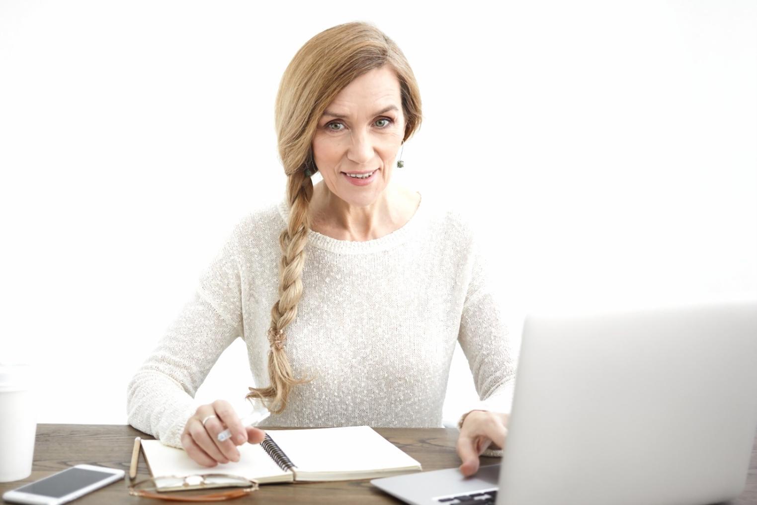 Person reviewing financial documents and planning budget at desk